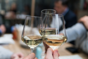 Champagne glasses clinking in hospitality facility